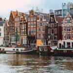 Colourful canal houses and boats in Amsterdam