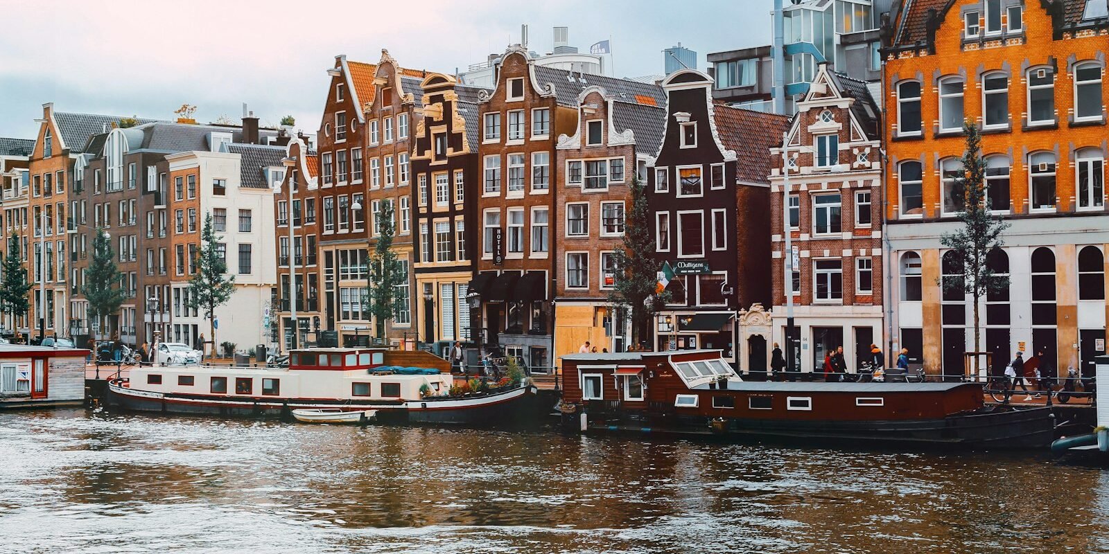 Colourful canal houses and boats in Amsterdam