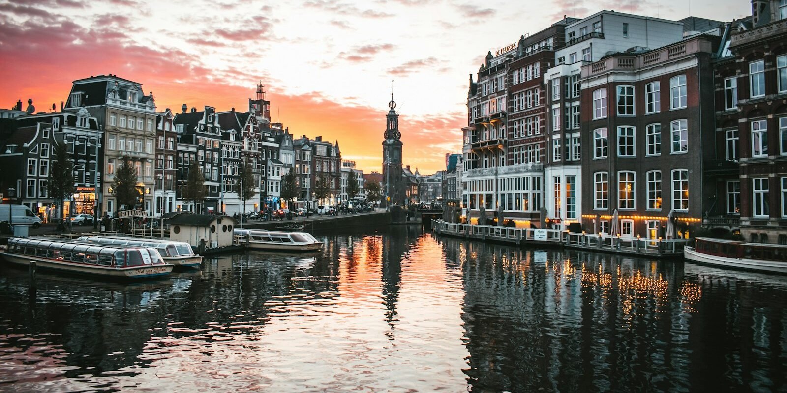 Canal houses reflected in an Amsterdam canal at sunset