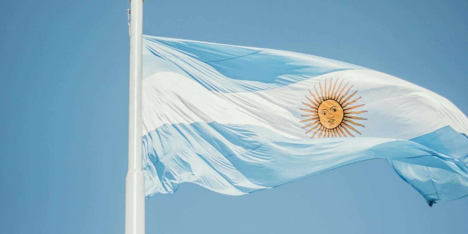 Argentine flag against a blue sky
