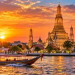 Wat Arun temple on the Chao Phraya river in Bangkok at sunset