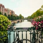 Flowers and bicycles on an Amsterdam canal bridge
