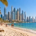 Dubai beach and skyline on a sunny winter day with palm trees