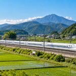 White bullet train passing through the Japanese countryside