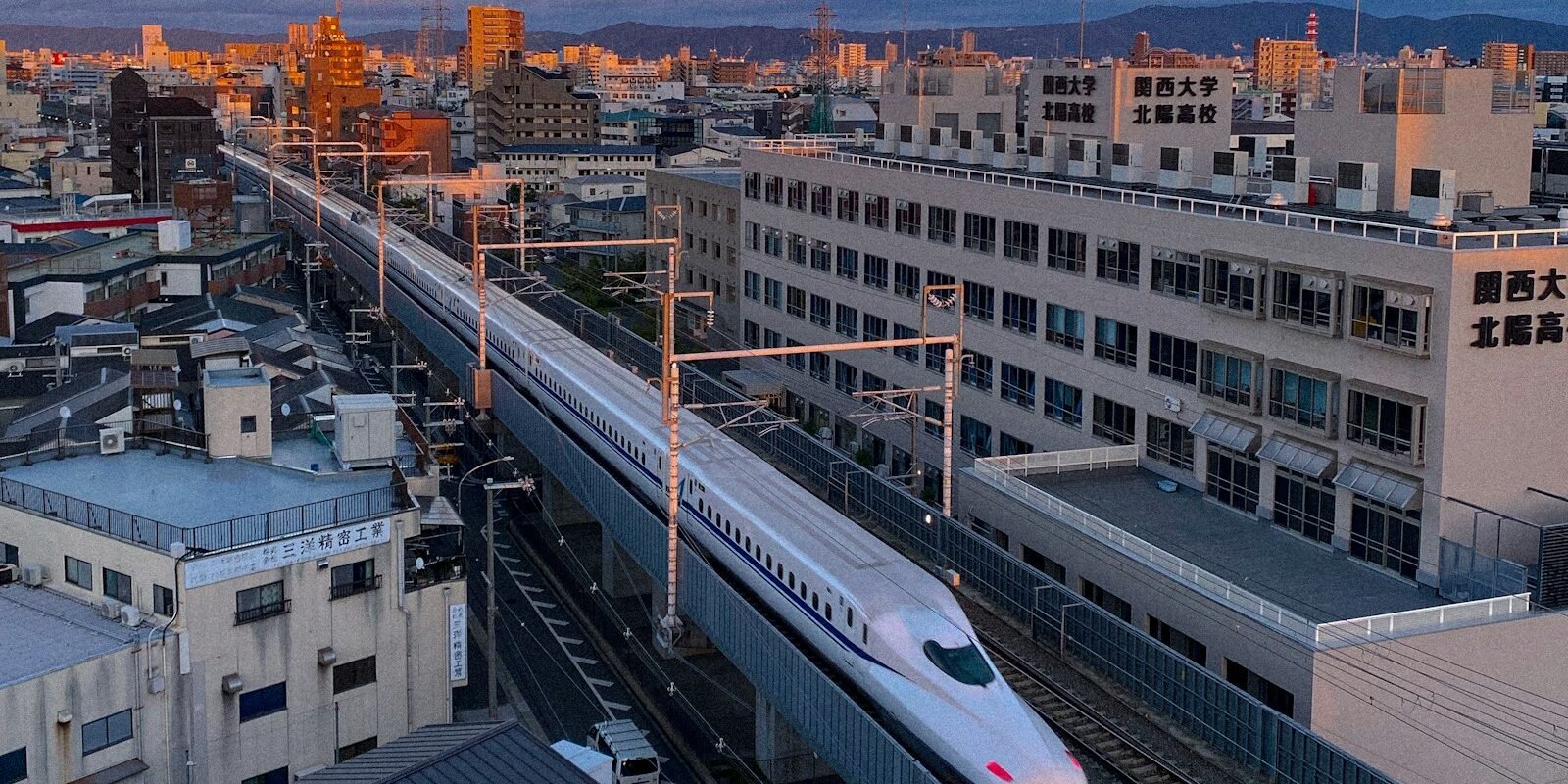 A bullet train passing through a Japanese city