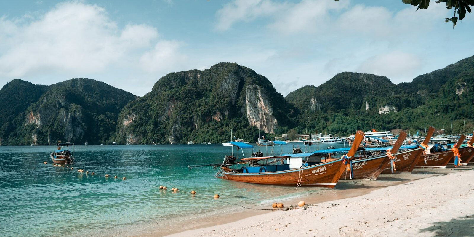 Longtail boats on a beach in southern Thailand