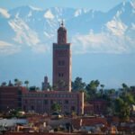 The Koutoubia minaret with the snow-capped Atlas Mountains behind Marrakech