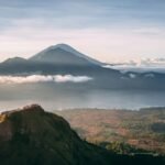 Mount Batur volcano above the clouds at sunrise