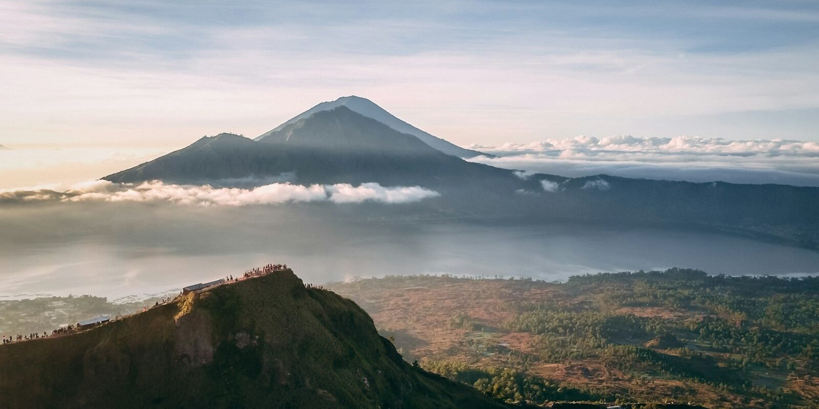 Mount Batur volcano above the clouds at sunrise