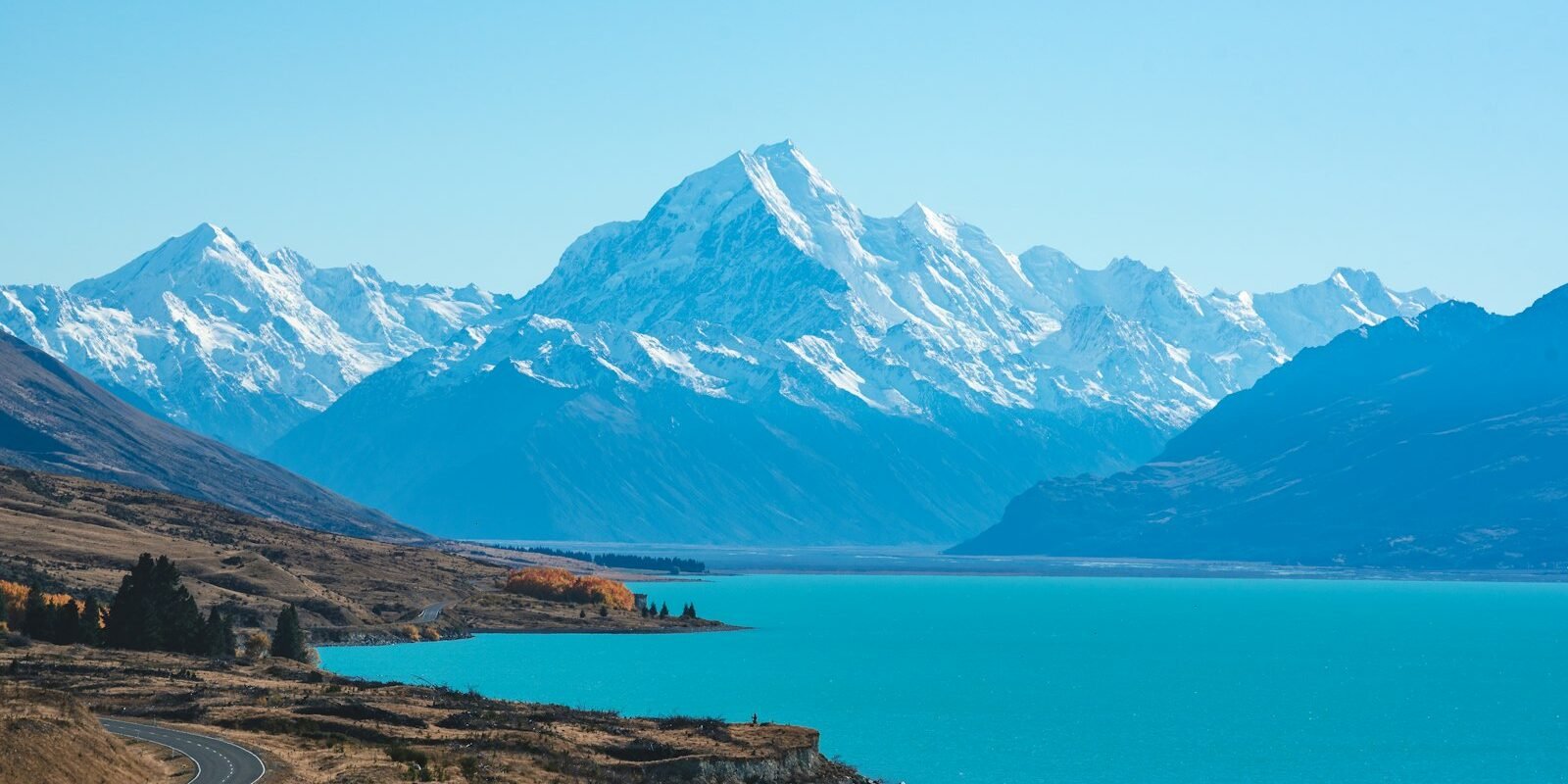 Snow-capped mountain and turquoise lake in New Zealand