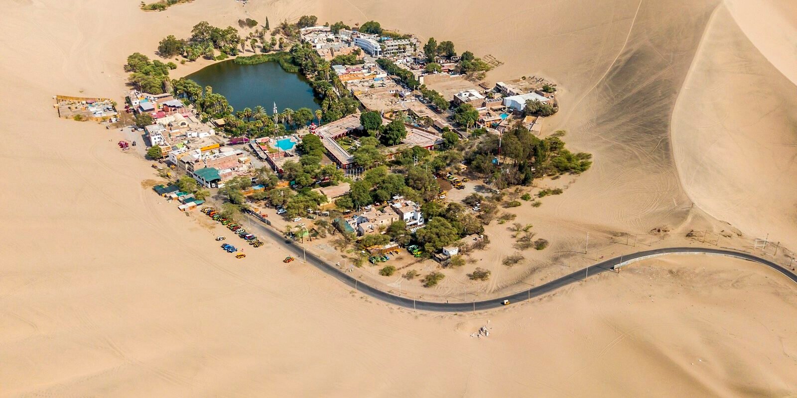 Huacachina oasis surrounded by sand dunes