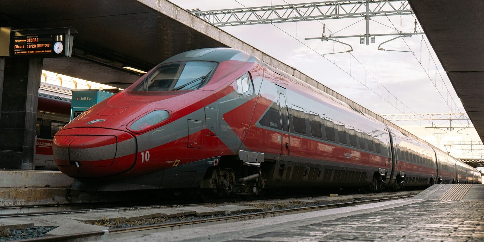 A high-speed train at a railway platform in Rome