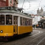 A yellow tram on a Lisbon street