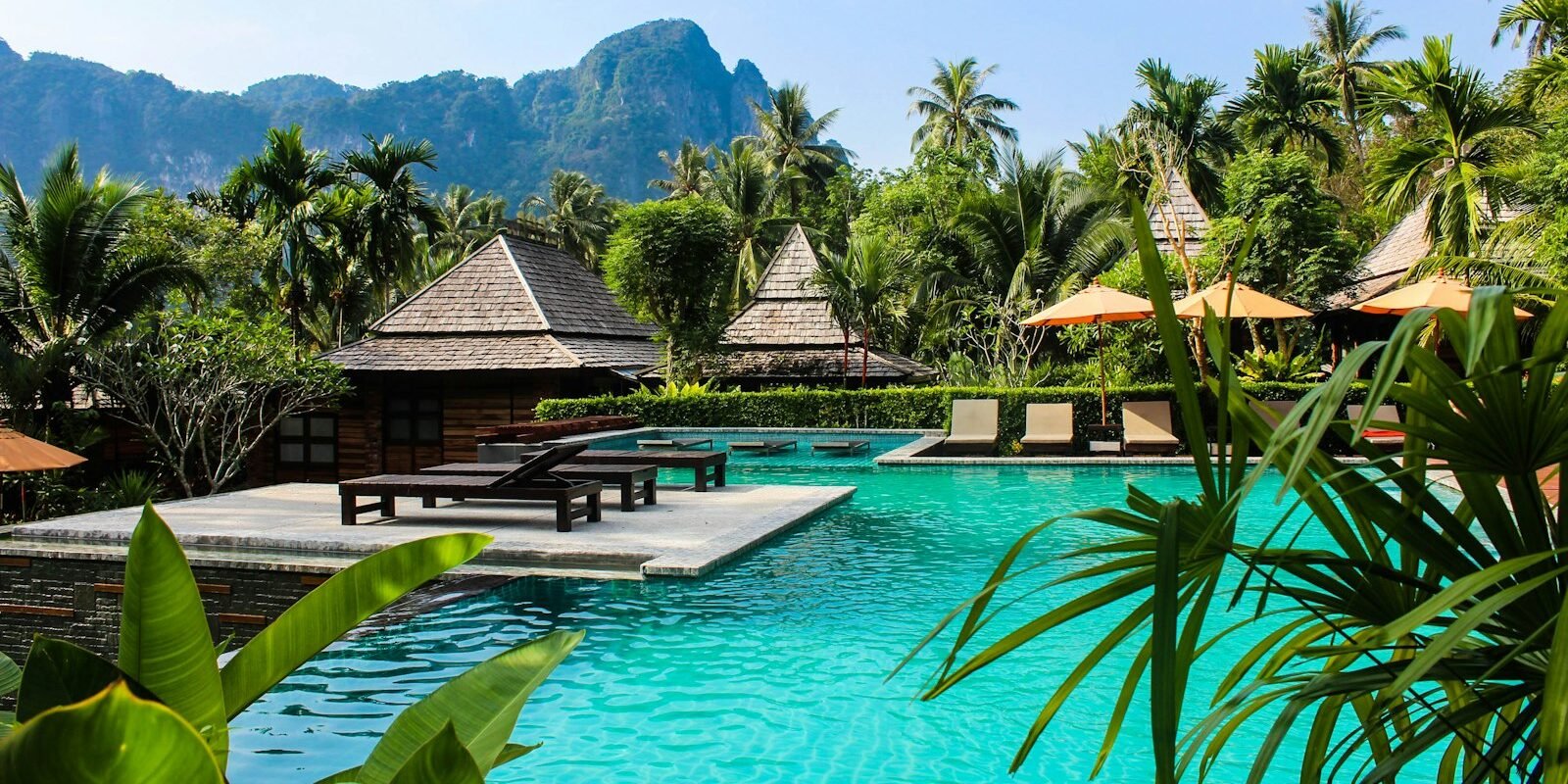 A resort pool surrounded by palm trees in Bali